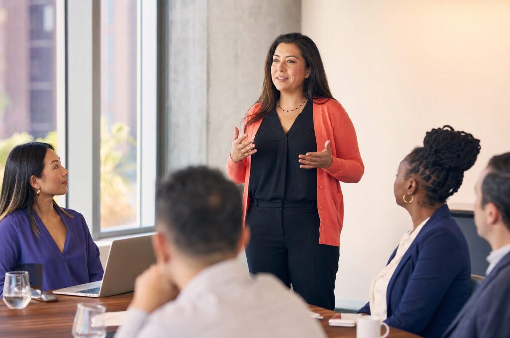 Manager delivering a confident presentation after business English communication training